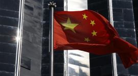 A Chinese flag is hoisted outside a commercial building in Shenzhen, China’s southern Guangdong province china, china helicopter, china attack helicopter, china unmmanned attack helicopter, china news, indian express news