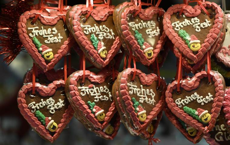 Gingerbread, reading 'Happy Feast', is sold at a traditional Christmas market in the center of Muenster, Germany, Thursday, Dec. 8, 2016. (AP Photo/Martin Meissner)