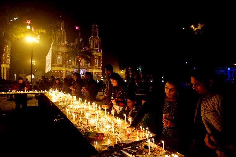 Indians light candles and offer prayers on the eve of Christmas at the Sacred Heart Cathedral in New Delhi, India, Saturday, Dec. 24, 2016. Though the Hindus and Muslims comprise majority of the population in India, Christmas is a national holiday celebrated with much fanfare. (AP Photo/Manish Swarup)