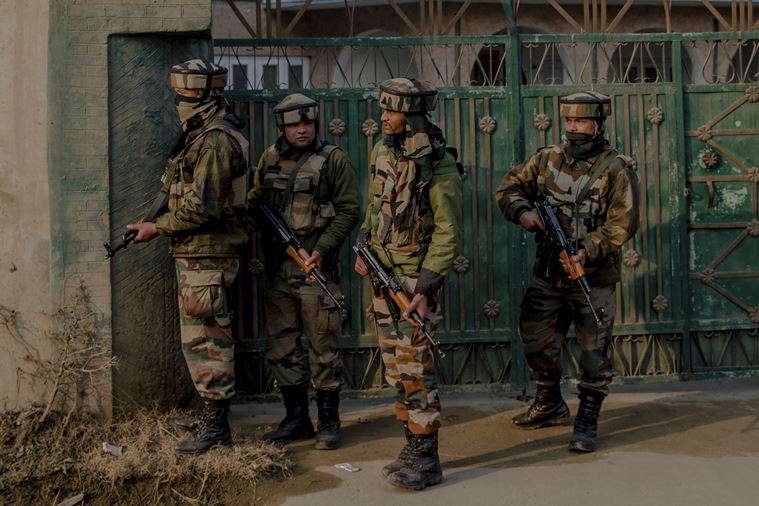 Soldiers take position during a search operation after terrorists ambushed an army convoy in Pampore, on the outskirts of Srinagar. (AP Photo/Dar Yasin)