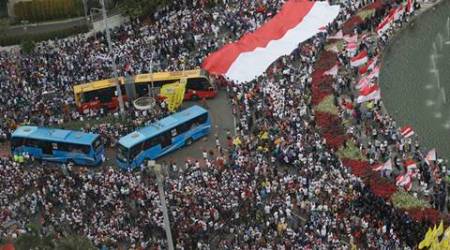 Indonesians gather for a rally at the Selamat Datang, or Welcome, Roundabout in Jakarta, Indonesia, Sunday, Dec. 4, 2016. Thousands of people staged a rally in attempt to demonstrate national unity as religious and racial tensions divide the world's most populous Muslim nation. (AP Photo/Achmad Ibrahim)
