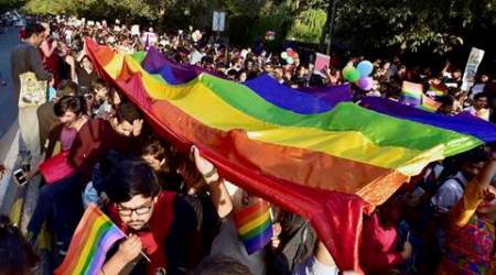New Delhi: LGBT Community members and supporters carry a rainbow-colored banner during the Delhi Queer Pride March in New Delhi on Sunday. PTI Photo by Kamal Singh (PTI11_27_2016_000185B)