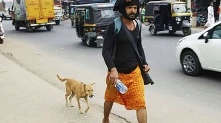 kerala stray dogs, kerala dog follows man, dog follows man on sabarimala pilgrimage, man's best friend dog, kerala stray dog follows man to sabarimala, kerala dog accompanies man on sabarimala pilgrimage, indian express, indian express news, trending, trending in india, viral