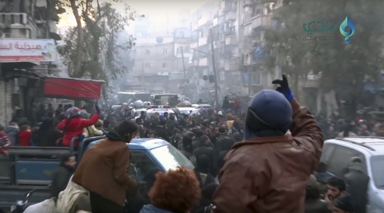 This frame grab from video provided by Baladi News Network, a Syrian opposition media outlet that is consistent with independent AP reporting, shows civilians gathering for evacuation from eastern Aleppo, Syria, Thursday, Dec. 15, 2016. The Russian military said over 1,000 people have been evacuated from Aleppo under a cease-fire deal reached with Syrian rebels. France's ambassador to the United Nations says international observers should monitor the safe evacuation of civilians and fighters from the war-torn Syrian city of Aleppo. (Baladi News Network via AP)