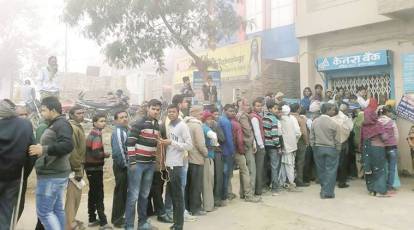 Cash for queues: people paid to stand in line amid India's bank note crisis, India