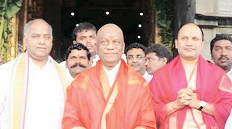 Reddy (far right in frame) next to CM O Panneerselvam at Tirupati temple.