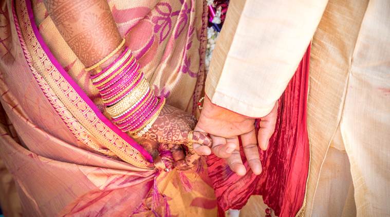 A ritual in Indian Hindu Wedding. Bride and groom holding hands.