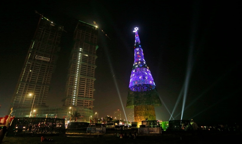 An enormous artificial Christmas tree is seen lit up after its unveiling in Colombo, Sri Lanka, Saturday, Dec. 24, 2016. Sri Lanka has unveiled a towering Christmas tree, claiming to have surpassed the world record for the tallest artificial Christmas tree.(AP Photo/Eranga Jayawardena)