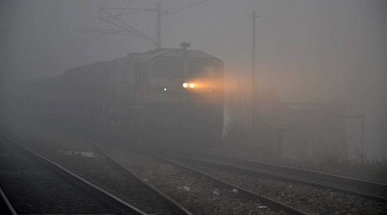 Mirzapur: Train runs through dense fog in Mirzapur on Wednesday. PTI Photo(PTI11_30_2016_000150B)