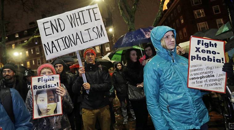 Protesters hold signs outside Harvard's John F. Kennedy School of Government, Wednesday, Nov. 30, 2016, in Cambridge, Mass. where the Institute of Politics is hosting a forum featuring political strategists from the 2016 presidential election campaigns. President-elect Donald Trump advisor, Stephen K. Bannon, was on the list of those scheduled to attend, but reportedly changed his plans. (AP Photo/Elise Amendola)