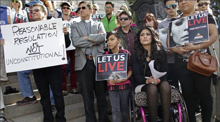 An 18-year-old who was shot in the back outside her high school in 2010,and is paralyzed from the waist down,participates in a gun control rally on the steps of the Colorado State Capitol,in Denver. (AP)