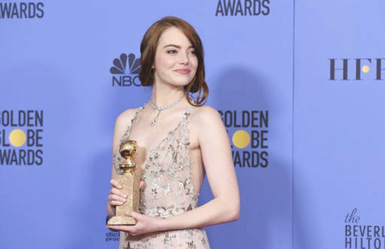 Emma Stone poses in the press room with the award for best performance by an actress in a motion picture - musical or comedy for "La La Land" at the 74th annual Golden Globe Awards at the Beverly Hilton Hotel on Sunday, Jan. 8, 2017, in Beverly Hills, Calif. (Photo by Jordan Strauss/Invision/AP)