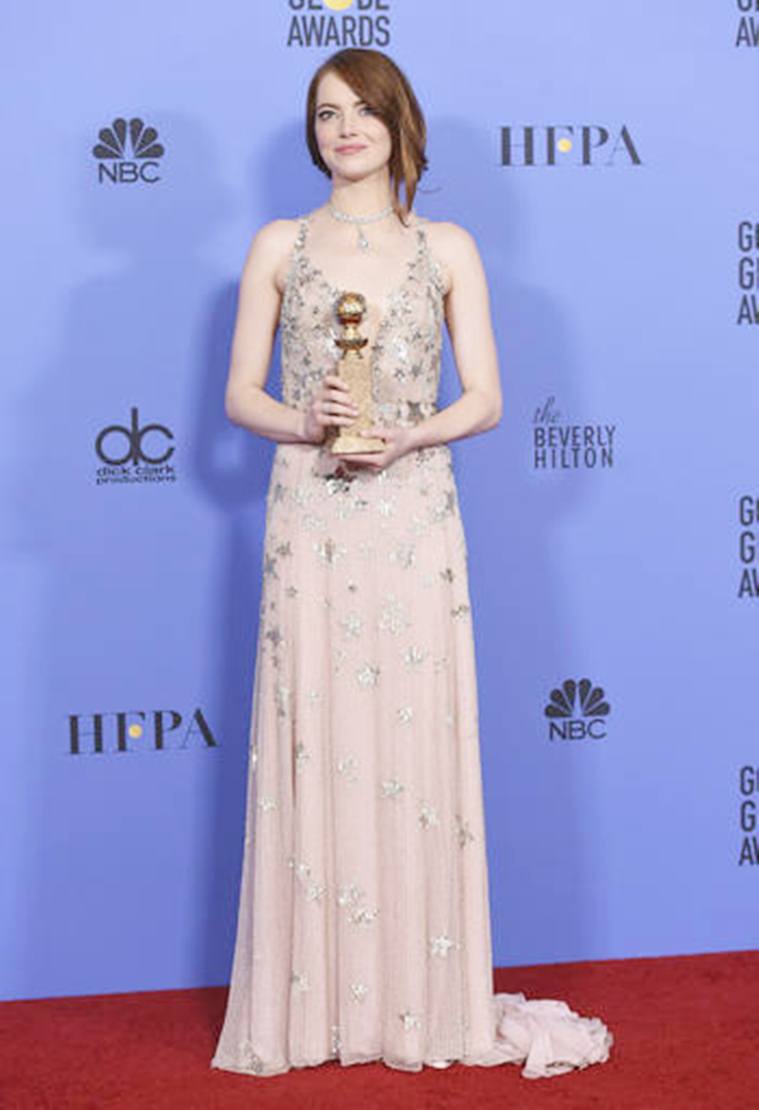 Emma Stone poses in the press room with the award for best performance by an actress in a motion picture - musical or comedy for "La La Land" at the 74th annual Golden Globe Awards at the Beverly Hilton Hotel on Sunday, Jan. 8, 2017, in Beverly Hills, Calif. (Photo by Jordan Strauss/Invision/AP)