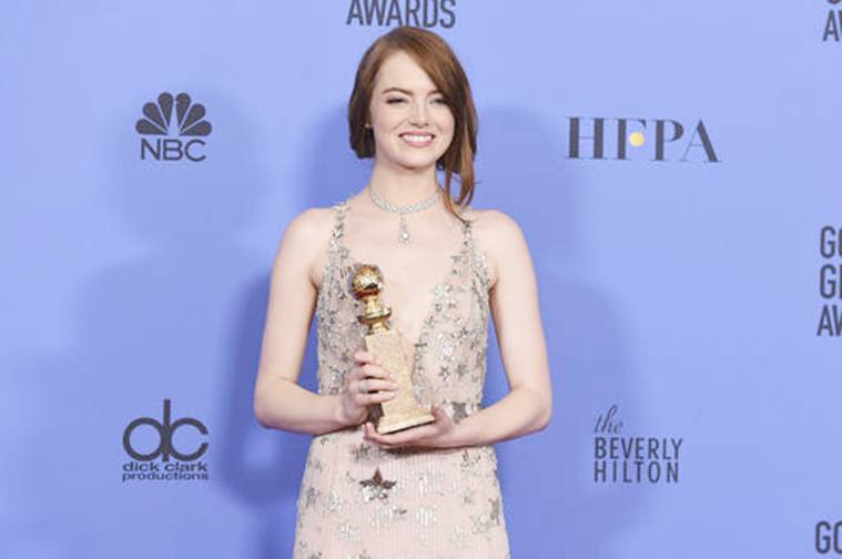 Emma Stone poses in the press room with the award for best performance by an actress in a motion picture - musical or comedy for "La La Land" at the 74th annual Golden Globe Awards at the Beverly Hilton Hotel on Sunday, Jan. 8, 2017, in Beverly Hills, Calif. (Photo by Jordan Strauss/Invision/AP)