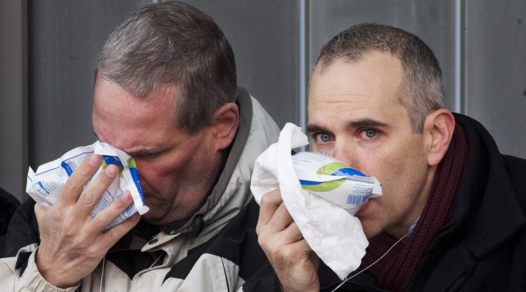 Two injured passengers sit outside the Atlantic Terminal after a Long Island Rail Road incident, Wednesday, Jan. 4, 2017, in the Brooklyn borough of New York. Officials said a commuter train either hit something or derailed as it arrived at the terminal. (AP Photo/Mark Lennihan)