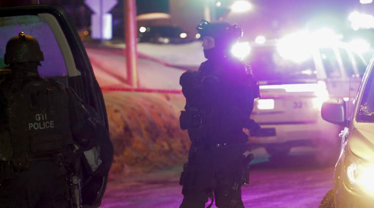 Police survey the scene after a deadly shooting at a mosque in Quebec City, Canada, Sunday, Jan. 29, 2017. Quebec Premier Philippe Couillard termed the act "barbaric violence" and expressed solidarity with victims' families. (Francis Vachon/The Canadian Press via AP)