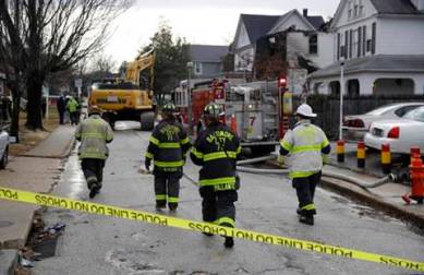 Fire officials approach the scene of an early morning house fire in Baltimore, Thursday, Jan. 12, 2017. A woman and several children in the house were injured and multiple other children in the family are unaccounted for, a fire official said Thursday. (AP Photo/Patrick Semansky)