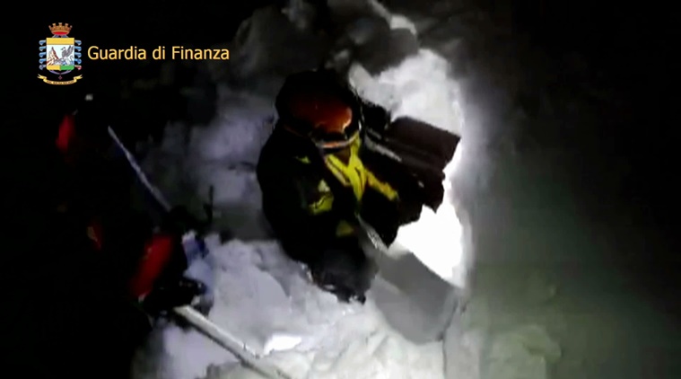 This photo taken from a video shows rescuers shoveling their way as they try to get inside the Hotel Rigopiano following an avalanche in Farindola, Italy, early Thursday, Jan. 19, 2017. A hotel in the mountainous region hit again by quakes has been covered by an avalanche, with reports of dead. Italian media say the avalanche covered the three-story hotel in the central region of Abruzzo, on Wednesday evening. (Italian Finance Police via AP)