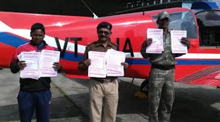 Cops posing with pamphlets that were airdropped in naxal-affected Simdega district to raise awareness about activities and rewards of Left-Wing Extremists. (Source: Jharkhand Police media cell)