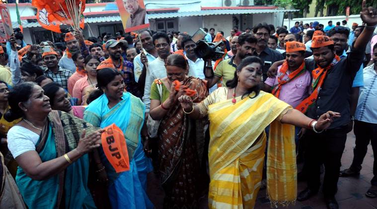 BJP woman worker does a little dance before State party office in Bhubaneswar during Vijay Utsav celebrations. (Express photo)