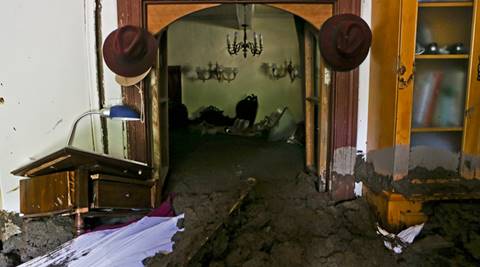 Sludge fills the home of Gabriel Lopez, brought by the overflowing of the Estero San Jose River in San Alfonso, Santiago, Chile, Sunday, Feb. 26, 2017. Floods caused by Andean rainfall are causing havoc in parts of Chile, triggering landslides, cutting roads and isolating thousands of people. (AP Photo/Esteban Felix)