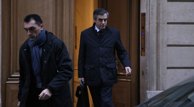 Conservative presidential candidate Francois Fillon leaves his home in Paris, Thursday, Feb. 2, 2017. Fillon has been under a preliminary probe since news reports said he paid his wife Penelope and two of the couple's children nearly one million dollars from public funds over the years for allegedly fake jobs as his parliamentary aides. (AP Photo/Thibault Camus)