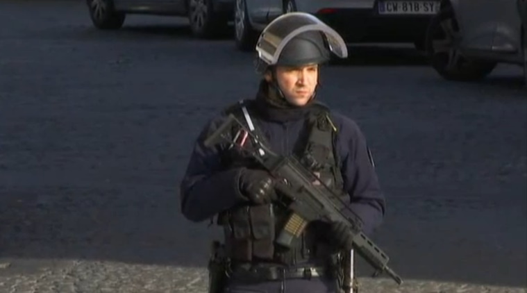 In this image made from video, a security official stands guard outside the Louvre Museum in Paris, France. Paris police said a soldier has opened fire outside the Louvre Museum. (AP Photo)