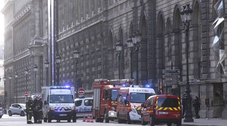 Police and rescue workers car park outside the Louvre museum in Paris,Friday, Feb. 3, 2017. Paris police say a soldier has opened fire outside the Louvre Museum after he was attacked by someone, and the area is being evacuated. (AP Photo/Thibault Camus)