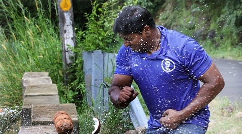 Man smashes coconuts. man smashes 124 coconuts. Kerala man smashing coconuts, Domanic smashing coconuts, Sobha City Mall, indian express, indian express news