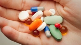 Pills on person’s palm vietnam, vietnam cops, vietnam mobile labs, ecstasy pills