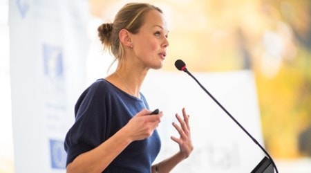 Pretty, young business woman giving a presentation in a conference/meeting setting (shallow DOF; color toned image)