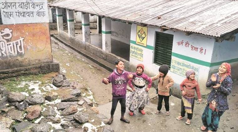 Outside a school that will serve as a poll booth, children enjoying the rain that has melted the snow. This booth, in Janaki Chatti village, the base station of the Yamunotri shrine, will be the last in Uttarakhand before the China border. (Source: Express photo by Ashutosh Bhardwaj)