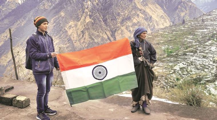 Bhagirathi Devi with her grandson. Her son, who was with the Assam Rifles, died in an IED blast in Assam. His coffin arrived draped in this Tricolour, which she has kept. “I will vote for the person who gives jobs to my grandsons,” she says. (Source: Express photo by Ashutosh Bhardwaj)