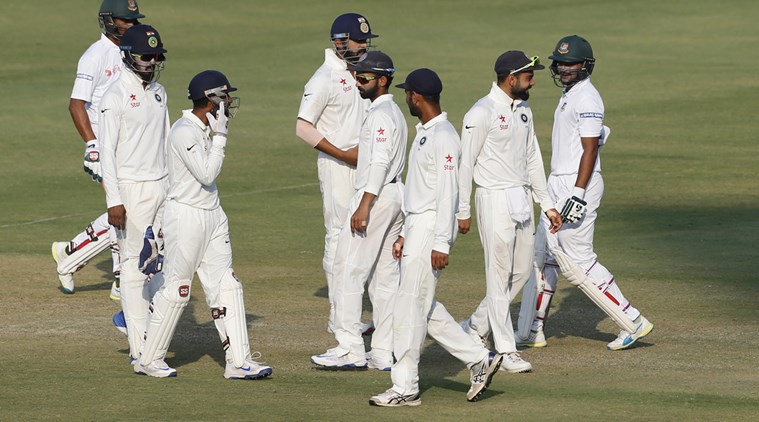 Bangladesh's Shakib Al Hasan, right, shares a light moment with India's captain Virat Kohli, second right, as they leave the ground at the end of fourth day's play of the cricket test match in Hyderabad, India, Sunday, Feb. 12, 2017. (AP Photo/Aijaz Rahi)