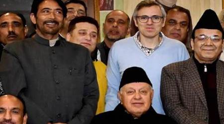 Srinagar: Former Chief Minister and National Conference working President Omar Abdullah along with his Father and party candidate for Srinagar seat Farooq Abdullah and JK Congress chief and candidate for Anantnag Parliamentary election seat Ghulam Ahmad Mir poses for a photograph with Young Congress and NC Leaders during a joint election rally in Srinagar on Sunday. PTI Photo  (PTI3_19_2017_000147A)