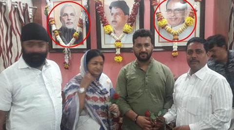 narendra modi, pm modi, shivraj singh chauhan, floral trivute pm modi, garland on modi picture, indore mayor, indore mayor floral tribute pm modi, india news, bizarre news, odd news, indian express