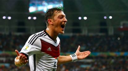Mesut Ozil of Germany celebrates with the trophy following the