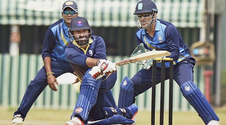 Nadia: J-K Captain Parvez Rasool playing a shot as Jharkhand Captain M S Dhoni looks on during the Vijay Hazare Trophy at Nadia in West Bengal on Monday. PTI Photo by Ashok Bhaumik(PTI3_6_2017_000089B)