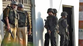 ATS commandos stand guard outside a house where a suspected militant is said to be hiding in Thakurganj area in Lucknow lucknow terrorist attack, lucknow terrorist firing, thakurganj firing, Bhopal-Ujjain train blast, Bhopal-Ujjain train explosion, UP arrest, terrorist arrest, terrorism, islamic state, ISIS, indian express news, india news