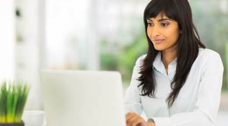pretty indian businesswoman using computer in office