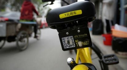 Close-up of a smartphone screen showing a bike-sharing app interface.