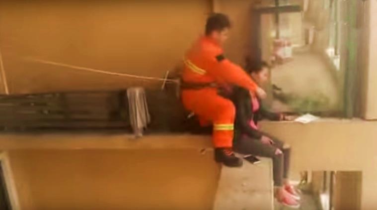 feel good videos, humanity videos, firefighter saves a woman from dying, indian express, indian expess news