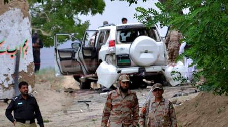 Pakistani security officials stand guard at the site of a suicide bombing which killed dozens of people and left many injured in Mastung district near Quetta, Pakistan, Friday, May 12, 2017. (AP Photo/Arshad Butt)