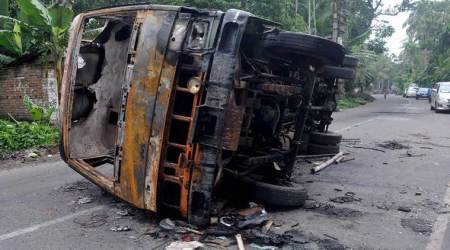 Baduria: A burnt vehicle seen at a road after a communal riot  at Baduria in North 24 Pargana district of West Bengal on Wednesday. PTI Photo  (PTI7_5_2017_000228B)