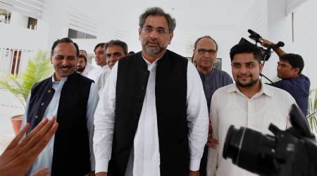 Pakistan's premier-designate Shahid Khaqan Abbasi, center, leaves with his aids after meeting with politicians in Parliament house in Islamabad, Pakistan, Monday, July 31, 2017. Pakistan's parliament will meet Tuesday to elect a new prime minister after the disqualification of three-term prime minister Nawaz Sharif. Sharif's Pakistan Muslim League party nominated Sharif's longtime loyalist Abbasi for the top slot on Saturday. (AP Photo/Anjum Naveed)