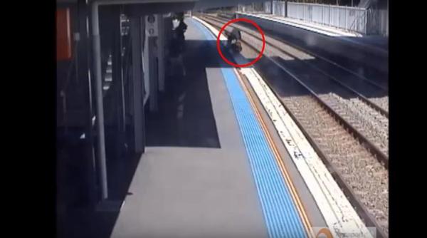 mom saves baby on tracks, pram rolls off platform, baby pram roll off platform, mom saves baby video, indian express, indian express news