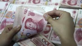 China sets yuan mid-point below key 7 per dollar for first time since 2008