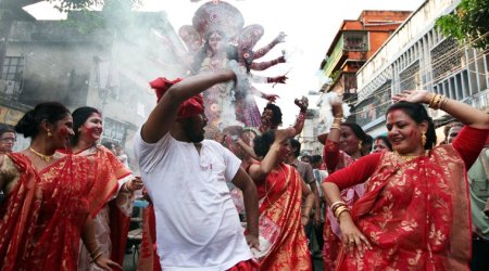 In it together: Revelry during an immersion procession in Kolkata. (Source: Express photo by Partha Paul)