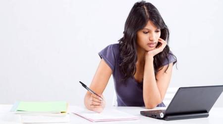young female university student studying in classroom