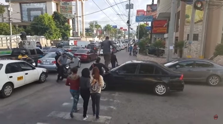 Watch: Pedestrians walk over car’s bonnet to teach the driver a lesson